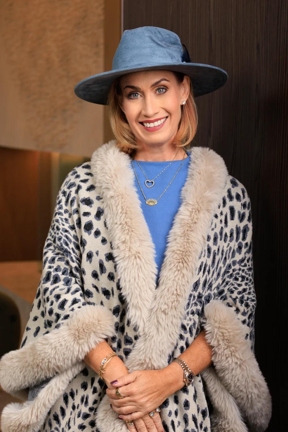 Cassandra L. Krcmar in a blue hat and leopard wrap